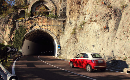 The car drove at speed into the tunnel.の写真素材