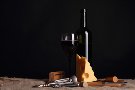 Cheese with holes and a glass of wine.の写真素材