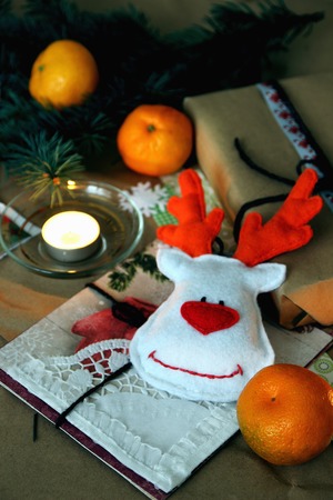 Postcards, and handmade toy on the background of Christmas decorations.の写真素材