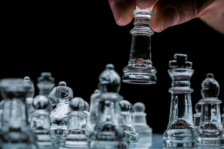 detail of glasschess board with male handの写真素材