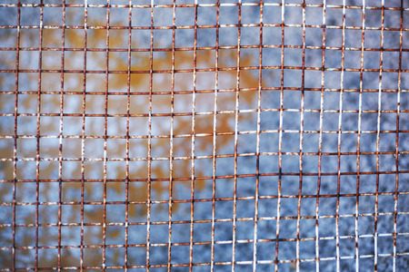 detail of rusty mesh fenceの写真素材