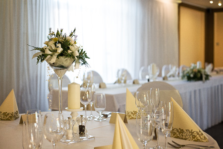Wedding table decoration with white flower centerpiece, taken in hotel restaurant before wedding receptionの写真素材