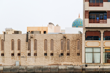 Detail of architecture in Bur Dubai with roof of Al Juma Mosque at the backgroundの写真素材