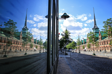 Slotsholmen, view on a famous Old Stock Exchange -Børsen. The tower with  "Dragon-spire" symbolizing the union of the Nordic countries - with three golden crownsの写真素材