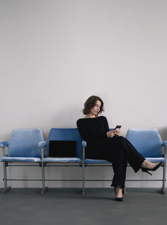 Businesswoman with phone and laptopの写真素材