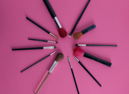 Makeup artist tools on a pink surfaceの写真素材