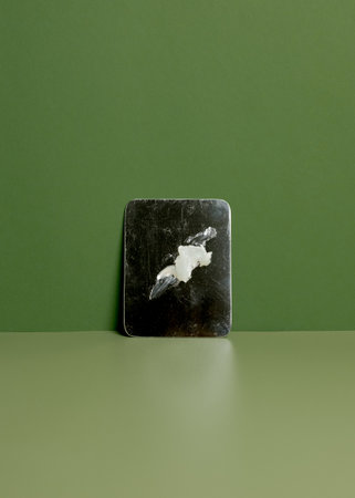 Transparent gel on a black square surface.