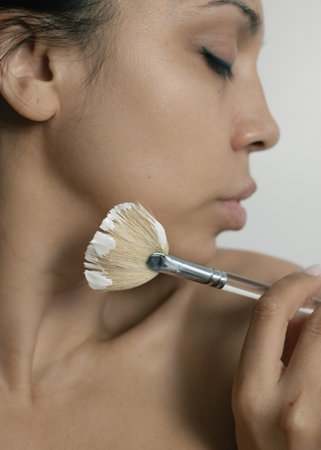 Woman holding brush for face mask