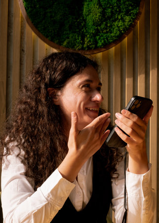 Woman laughing while holding her phone