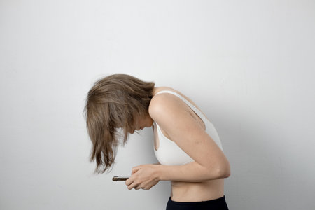 Woman seated with rounded shoulders, neck hump visible