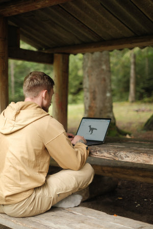 Freelancer with laptop in nature workspaceの写真素材