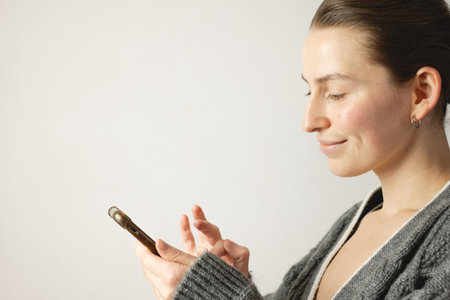 Relaxed woman using smartphoneの写真素材