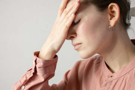 Woman holding her temples, headache