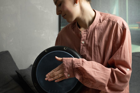 Female practicing on djembe drumの写真素材