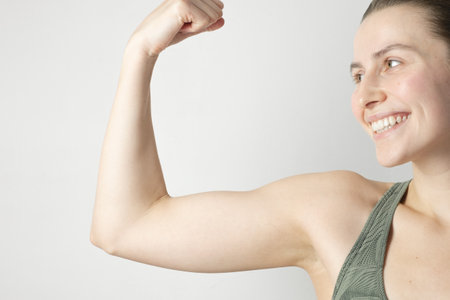 Fit woman flexing her musclesの写真素材