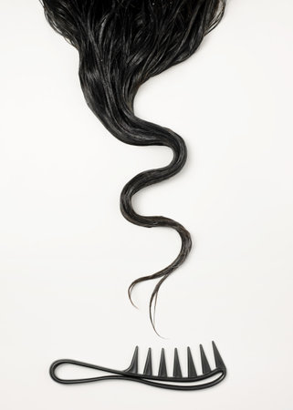 Curly dark hair on white background, curly hair care routineの写真素材