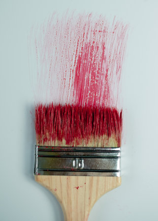 Paintbrush with red stroke on whiteの写真素材