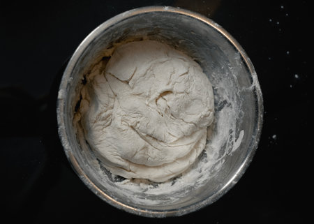 Dough in bowl, dark surface.の写真素材