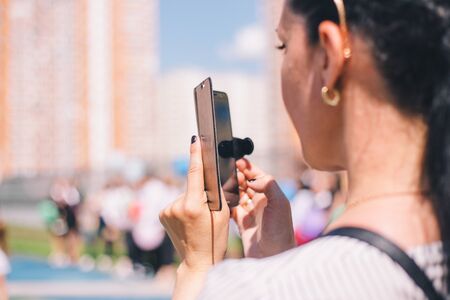 Close-up of a girl taking pictures on the phone