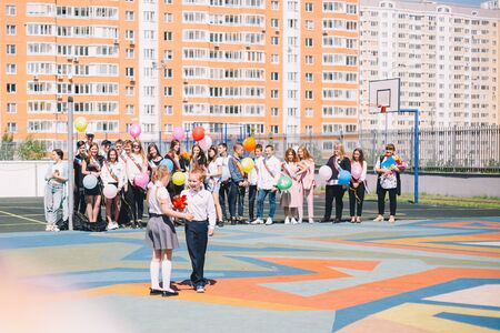 Moscow, Russia - 22 May 2019: Schoolchildren boy and girl ring the bell on the last bell and graduation with graduatesのeditorial素材