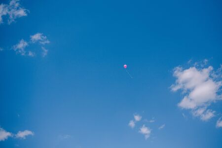 Multicolored balloons against the blue sky and clouds. Last call and graduation at schoolの写真素材