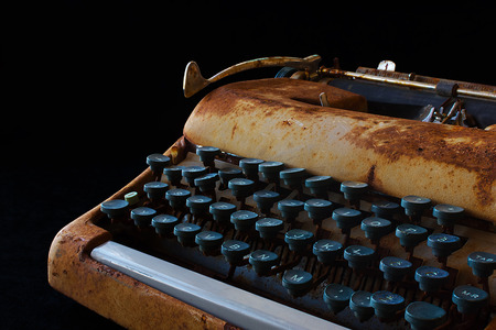 Typewriter, Waiting for Inspiration. Vintage Rusty Typewriter Machine. Journalist Equipment. Typewriter Close Up Isolated on Black Background.の写真素材