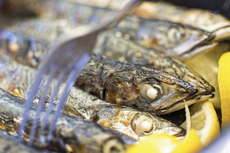 Grilled Fish with Lemons and Fork Close Upの写真素材