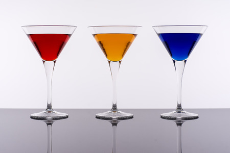 Colorful Cocktails in Martini Glasses Background. Bar Commercials Concept.の写真素材