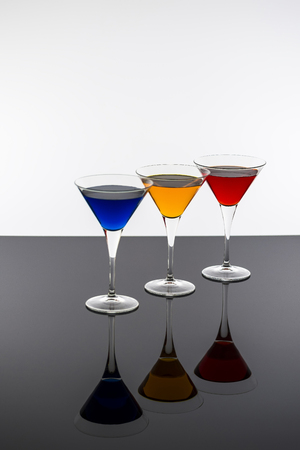 Colorful Cocktails in Martini Glasses Background. Bar Commercials Concept.の写真素材