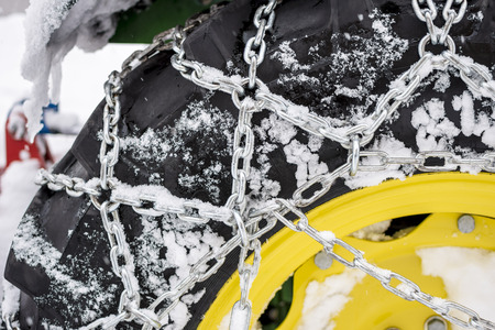 Tire With Mounted Snow Chains in the Winter Snowy Day