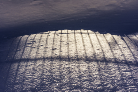 Abstract Vertical Shadows on the Snow. Texture Background Close Up on Winter Cold Day.の写真素材