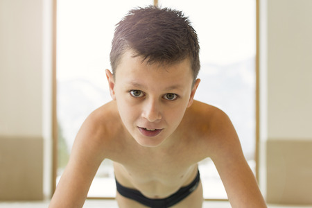 Portrait of Smiling Teen Boy in a Swimming Pool With Copy Spaceの写真素材