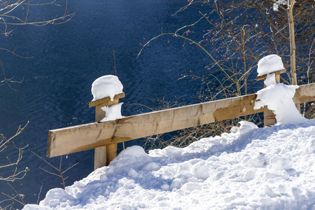 Snow Covered Wooden Fence on the Mountain Lake. Winter Landscape.の写真素材