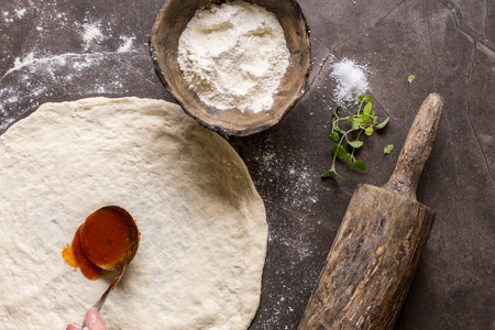 Raw Pizza Dough and Rolling Pin with Ingredients. Italian Pizza Making Concept.の写真素材