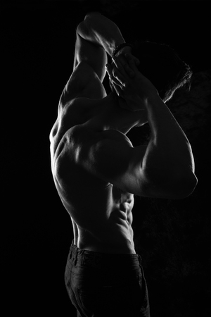 Sexy Shirtless Muscular Male Model on Black Backgroundの写真素材