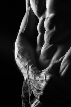 Sexy Athletic Male Model with Perfect Six Pack Abs on Black Backgroundの写真素材