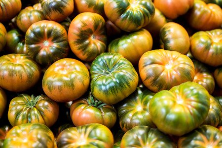 Organic Tomatoes Background. Stack of Organic Tomatoes Close Up.の写真素材