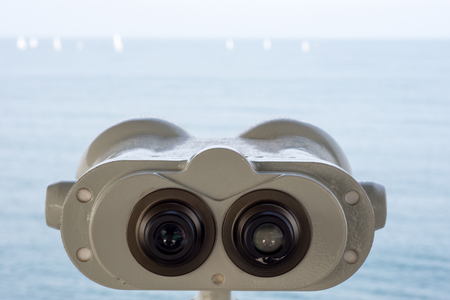 Binoculars Pointing Out to Sea and Sailingの写真素材
