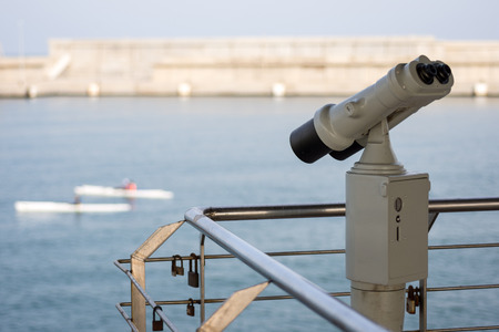 Binoculars Pointing Out to Sea and Sailingの写真素材
