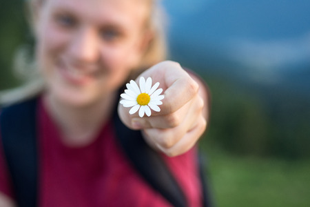 Happy Young Teenage Girl Holding Daisy Flowerの写真素材