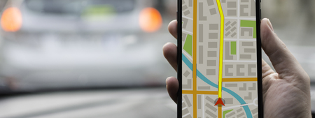 GPS Navigation on Mobile Phone Device and Transportation Concept. Male Hand Using Navigation System...