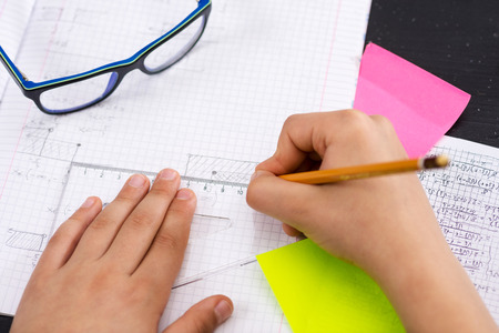 Schoolboy Hands with Ruler Drawing on White Paper. Mathematics Concept.の写真素材