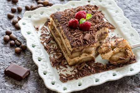 Tiramisu Cake with Grated Chocolate, Raspberry and Mint. Perfect Dessert.の写真素材