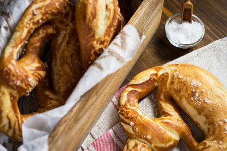 Pretzel with Sea Salt on Rustic Wooden Backgroundの写真素材