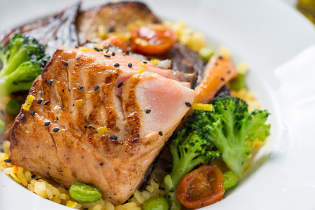 Grilled Salmon Fillets with Vegetables on White Plateの写真素材