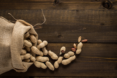 Rustic Style Peanuts in Shells on Wooden Background with Copy Spaceの写真素材