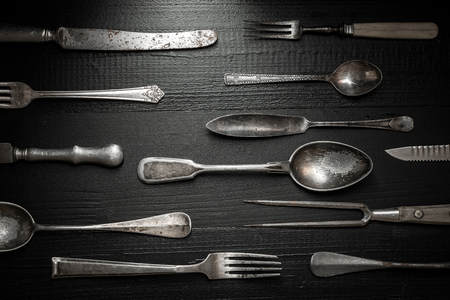 Old Rustic Cutlery on Dark Wooden Background.の写真素材