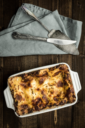 Lasagna with Minced Beef, Bolognese Sauce and  Mozzarella Cheese on Dark Wooden Background. Rustic Style.の写真素材