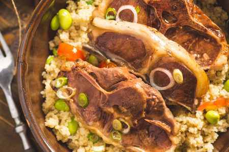 Roasted Lamb Loin Chops with Couscous and Soybean in Rustic Clay Dishの写真素材