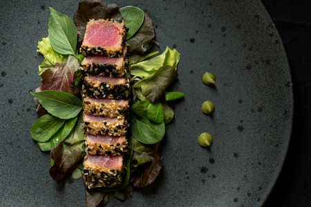 Grilled Sliced Tuna Steak in Sesame with Salad and Wasabi Sauceの写真素材